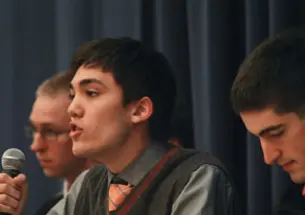 Christian Fong ’14 critiques Occupy Wall Street during a Jan. 13 debate. Listening are Kevin Henneck ’13, left, of the anti-Occupy side and Peter Favaloro ’12, right, of the pro-Occupy team.