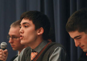 Christian Fong ’14 critiques Occupy Wall Street during  a Jan. 13 debate. Listening are Kevin Henneck ’13, left, of the anti-Occupy side and Peter Favaloro ’12, right, of the pro-Occupy team.