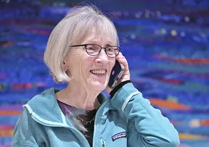 Harvard professor Claudia Goldin speaks to a reporter on the phone in her home in Cambridge, Massachusetts, after learning that she received the Nobel Prize in economics on Monday.