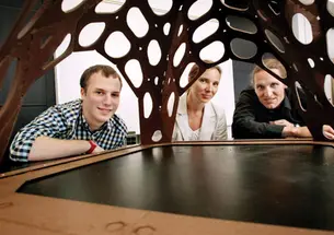 Admiring the chocolate pavilion created by Alex Jordan *13, left, are assistant professors Sigrid Adriaenssens and Axel Kilian.