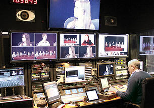 Students in an online course taught by Professor Jeremy Adelman are shown on screens at Princeton’s Broadcast Center as broadcast engineer Dan Kearns operates the console.
