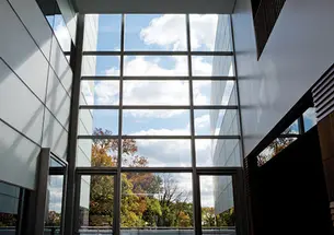 The view south from the two-story atrium of the neuroscience/psychology building; an outdoor patio is beyond the glass wall.