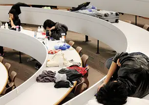 The “mental marathon” of HackPrinceton takes its toll Saturday night on students in a Friend Center lecture hall.