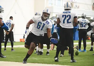 Caraun Reid ’14 (61) runs a drill with the Detroit Lions.