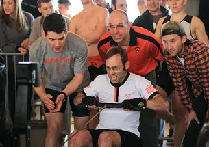 From left, Ted Moskovitz ’17, Greg Hughes ’96, and Keanan Clark ’13 cheer on Special Olympics rower Antony Pontoriero at the Crash P.
