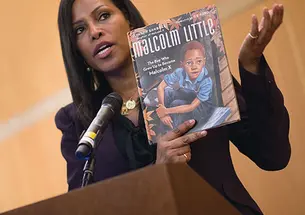 Ilyasah Shabazz with a book she wrote about her father, Malcolm X, as a child