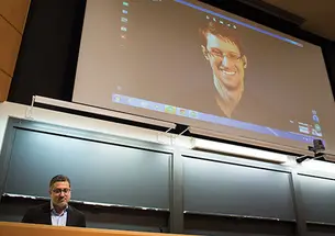 Journalist Bart Gellman ’82, left, talks with Edward Snowden via video link.
