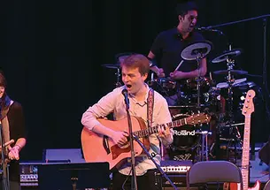 Performing “Death by Mall” during a concert by student songwriters are, from left, Sydney King ’17, Charlie Baker ’17, and Arjun Dube ’15 on drums.