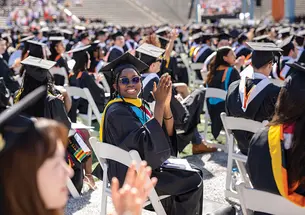 Graduate clapping in crowd