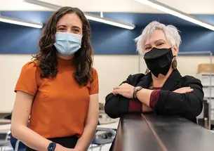 This is a photo of Natalka Pavlovsky *01, right, and Sophie Brady in a classroom..
