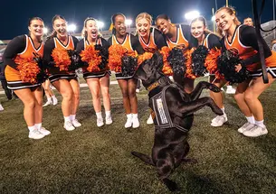 OTC_K9Coach-092923_0024 copy.jpg Coach the dog with cheerleaders