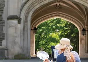 OTC_SpringCampus-050923_0017.jpg Person painting picture on site of Blair Arch