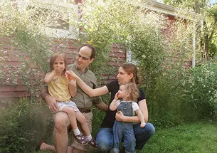 John Jameson ’04 enjoys his flower garden with his wife, Lucy ’06, and their daughters.