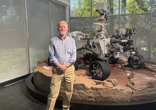 PRINCE_Chad-Edwards-Rover.jpg Photo of Chad Edwards ’79 in front of a full-scale model of the Perseverance rover