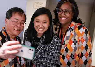 Three Alumni posing for selfie