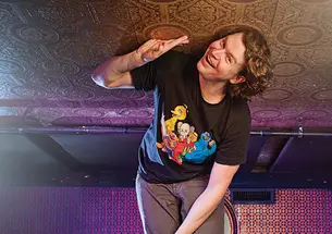 Zach Zimmerman on stool touching the ceiling