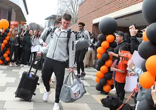 Students cheer for the men’s basketball players as they hit the road for Louisville, Kentucky, where they’ll play Creighton in the NCAA Sweet 16.