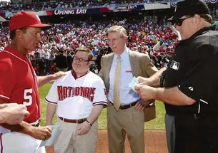 Baseball fan Jon Will, pictured with his father, gives the Washington Nationals’ lineup card to umpires on Opening Day in 2010.
