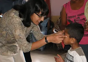A nonprofit founded by Ashanthi Pereira Mathai ’95, left, has provided prescription eyeglasses to 35,000 children and adults.