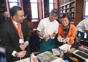 Chef Zar Ni, center, gave a lesson in making sushi to Karthick Ramakrishnan *02, left, and Jaime An-Wong s’75.
