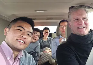 Frank Langfitt ’86 with his NPR assistant, Yang Zhuo (left), and passengers in the “Free Loving-Heart Taxi”