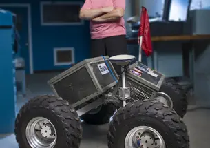 Laura Ray ’84 *91 with Yeti, the robot she and her students built.