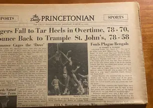 A yellowed copy of The Daily Princetonian on March 20, 1967, with a banner headline reading, "Tigers Fall to Tar Heels in Overtime, 78-70, Bounce Back to Trample St. John’s, 78-58."