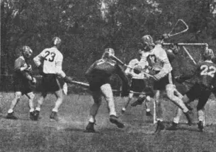 Princetonian19550512_LACROSSE.jpg Rutgers goalie Don Gucker leaps to stop a shot by Bob Russell ’55.