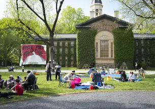 Pro-Palestinian protestors on Cannon Green; a sign reads "Free Free Palestine."