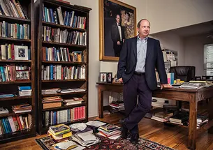 E. Randol Schoenberg ’88 at home in Los Angeles. The large framed picture is a portrait of him with the painting he helped retrieve.