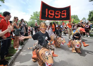 ReunionsSlideshow1.jpg Children "ride" on inflatable tigers with the Class of 1999 in the P-rade.