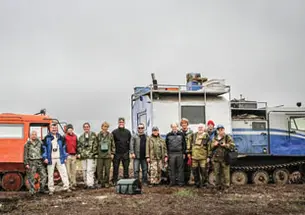 Members of the July 2011 expedition to Russia stand in front of trucks fitted with tank treads to crawl across the permafrost; from left, Bogdan Makovskii, Glenn MacPherson *81, Will Steinhardt, Chris Andronicos *99, Marina Yudovskaya, Luca Bindi, Victor 
