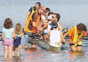 Coach Greg Hughes ’96 congratulates the men’s heavyweight varsity eight.