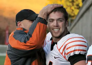Quarterback Quinn Epperly ’15 is congratulated after his sixth touchdown pass of the day beat Harvard, 51–48.