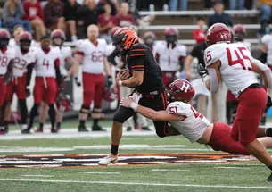Football player breaking a tackle