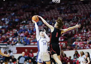 Senior guard Abby Meyers blocks a shot by a Kentucky guard during Princeton’s first game of March Madness in Bloomington, Indiana. 