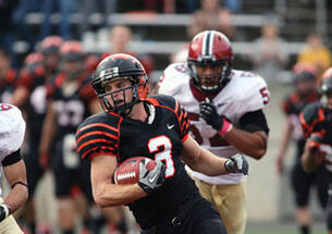 Roman Wilson ’14, shown in the fourth quarter, caught a 36-yard touchdown pass with 13 seconds left in the game to give the Tigers a 39–34 victory over Harvard.