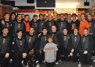 The lacrosse team with coach Chris Bates’ son, Nicholas, whose mother died of cancer last year.