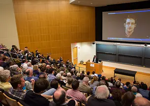 Edward Snowden, on video screen, spoke at a May 2 event moderated by Barton Gellman â82. (Tori Sulewski)
