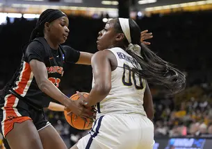 Madison St. Rose ’24, left, defends West Virginia guard Jayla Hemingway, with ball