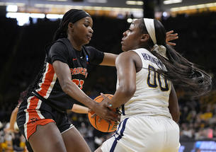 Madison St. Rose ’24, left, defends West Virginia guard Jayla Hemingway, with ball