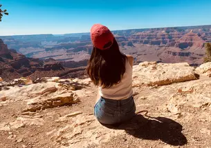 Cassandra James ’23 sits with her back to the camera, looking over a southwest scene.