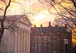 The sun rises over Princeton University campus buildings in 2014.