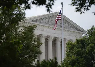 An American flag waves in front of the U.S. Supreme Court building, Monday, June 27, 2022, in Washington.