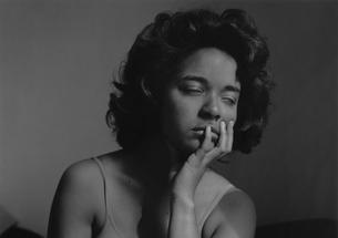 In this black-and-white photo, Carla Williams closes her eyes and rests her chin in her left hand.