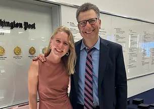Caroline Kitchener ’14 and her editor, Peter Wallsten, next to a display of Pulitzer Prizes won by The Washington Post.
