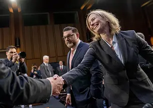 Kathleen Bradish ’94 shakes hands with Chairman Sen. Dick Durbin, D-Ill. at a Senate Judiciary Committee hearing to examine promoting competition and protecting consumers in live entertainment on Capitol Hill in Washington, in January 2023.