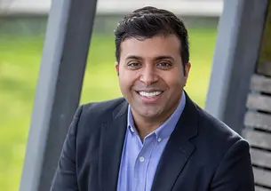 This is a headshot photo of Taleeb Noormohmaed ’98 outdoors.