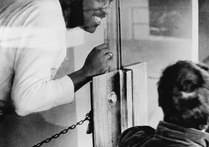 Brent Henry ’69, a leader of the Association of Black Collegians and today a Princeton trustee, behind the chained door of the New South administration building.
