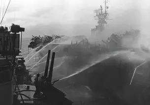 Alan Reed ’40 died after boarding the USS Princeton, in flames, Oct. 24, 1944. He was assigned to the USS Birmingham, shown here fighting the fire.